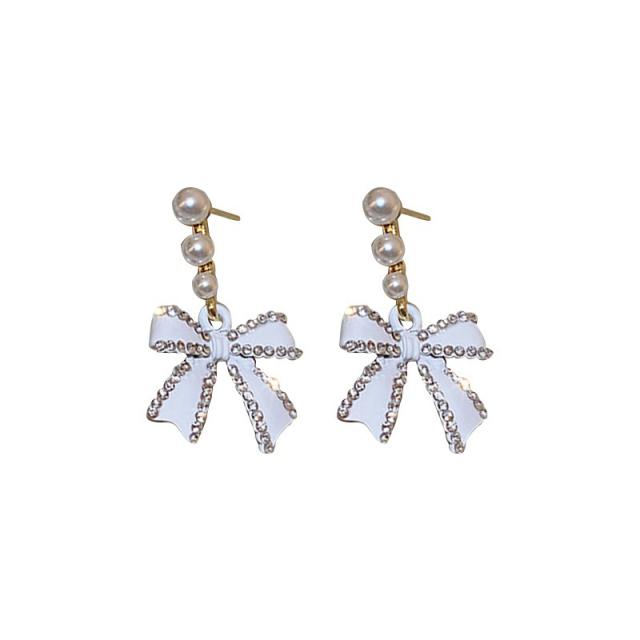 Diamond bow pearl earrings