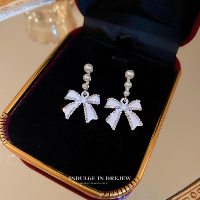 Diamond bow pearl earrings