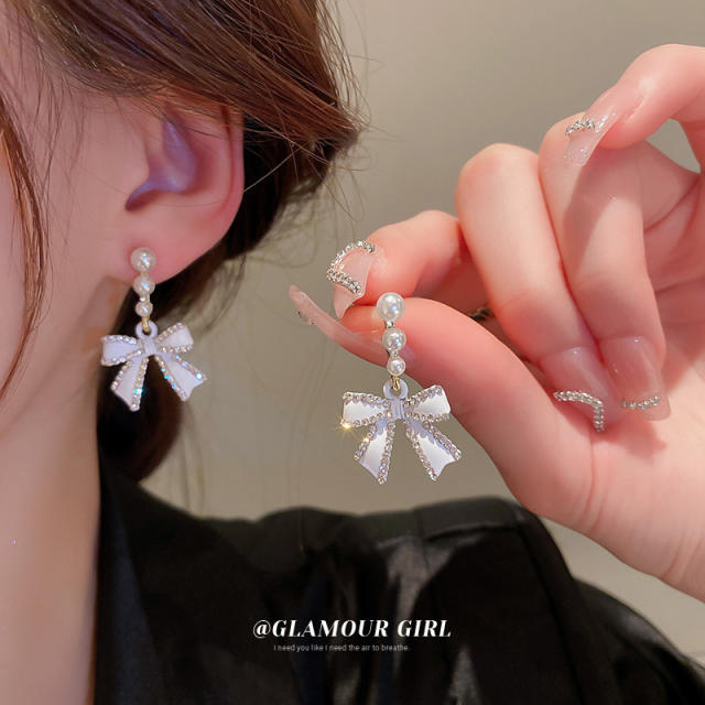 Diamond bow pearl earrings