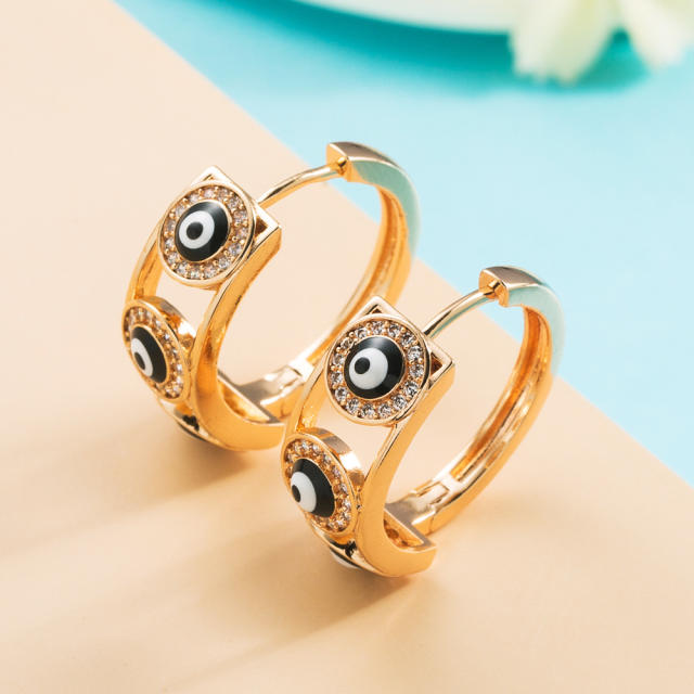 Enamel evil eye huggie earrings