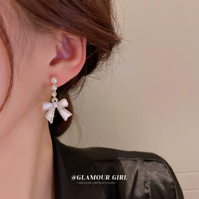 Diamond bow pearl earrings