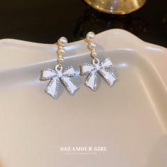 Diamond bow pearl earrings