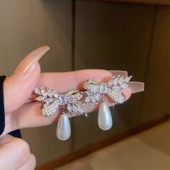 Crystal bow pearl drop earrings