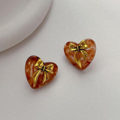 Concise gold color bow acrylic heart studs earrings