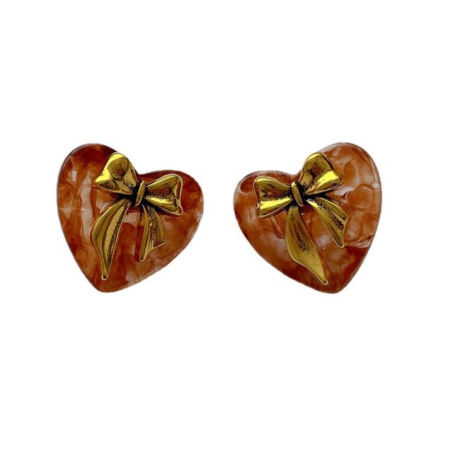 Concise gold color bow acrylic heart studs earrings