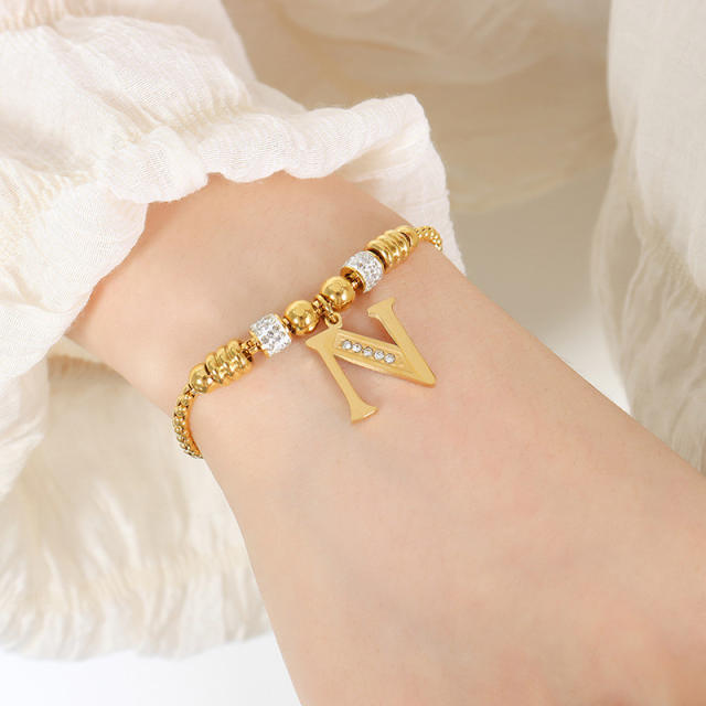 Delicate initial charm stainless steel slide bracelet