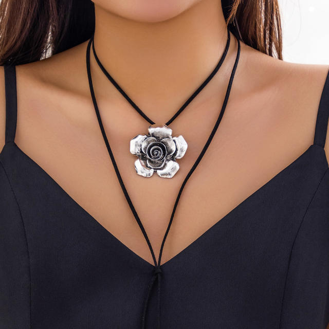 Vintage black velvet choker necklace with metal flower pendant
