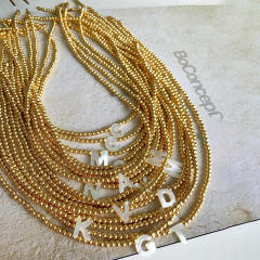 Natural shell initial letter gold plated copper beaded necklace