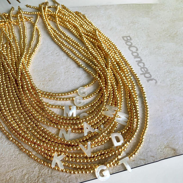 Natural shell initial letter gold plated copper beaded necklace