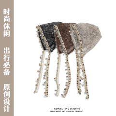 Bohemian-style slouchy beanie cap with cutouts shells tassels