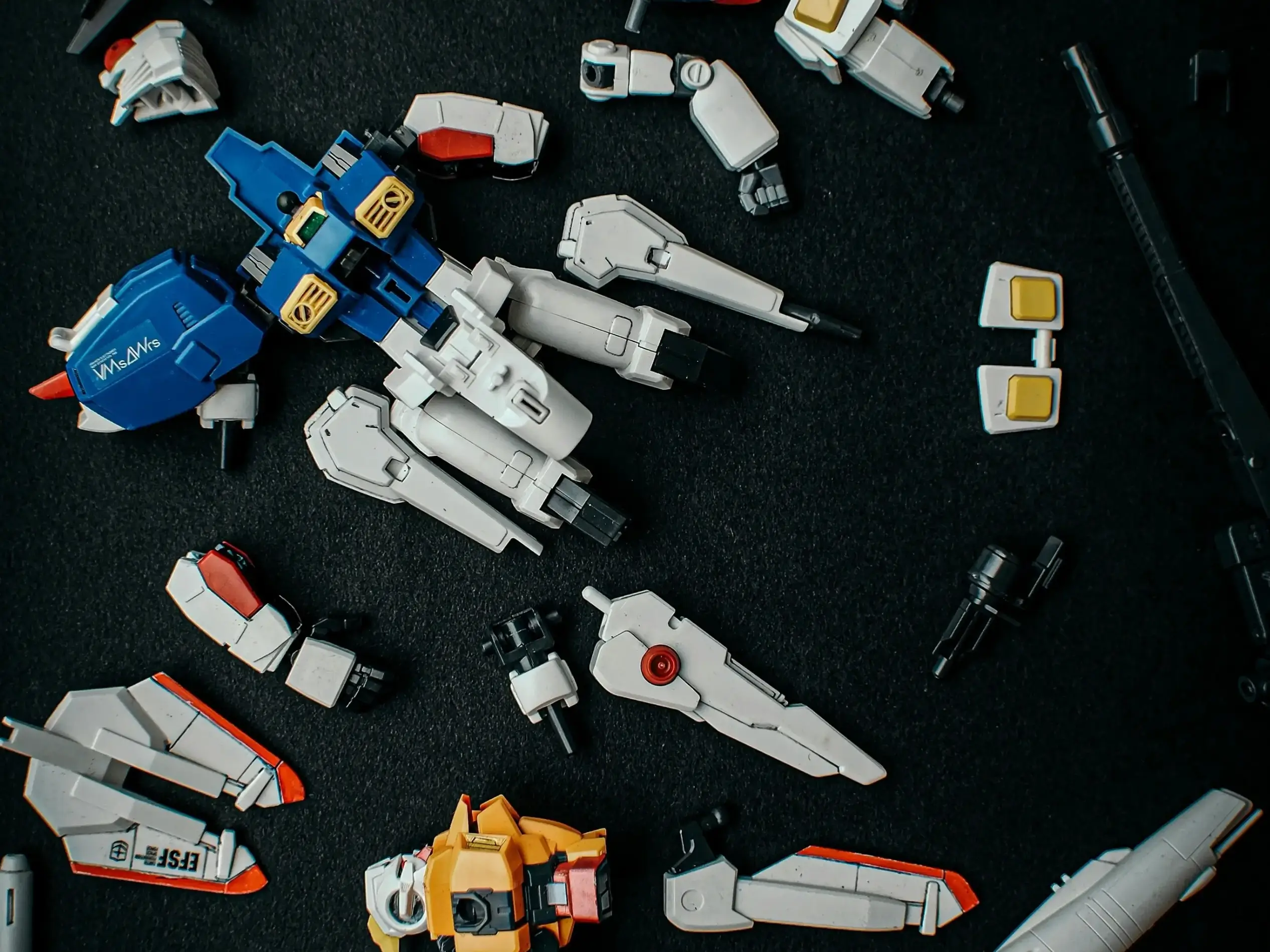 The parts of the Gundam figurines scattered on the ground.