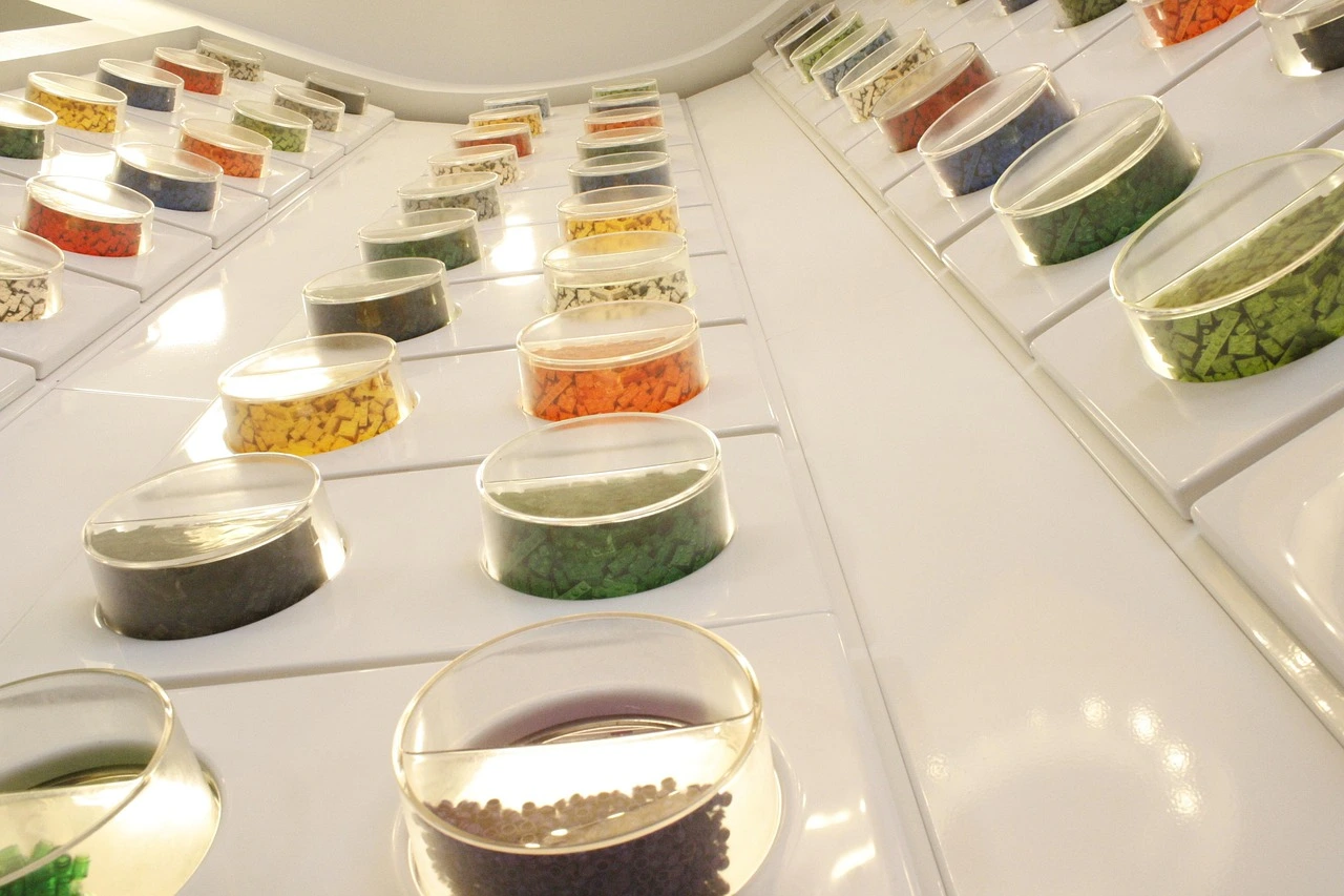 MOC blocks of different colors are placed in round transparent boxes.