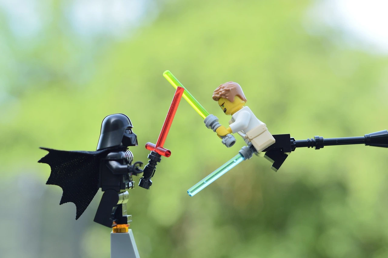 Two Star Wars minifigures are engaged in a fierce battle with weapons.