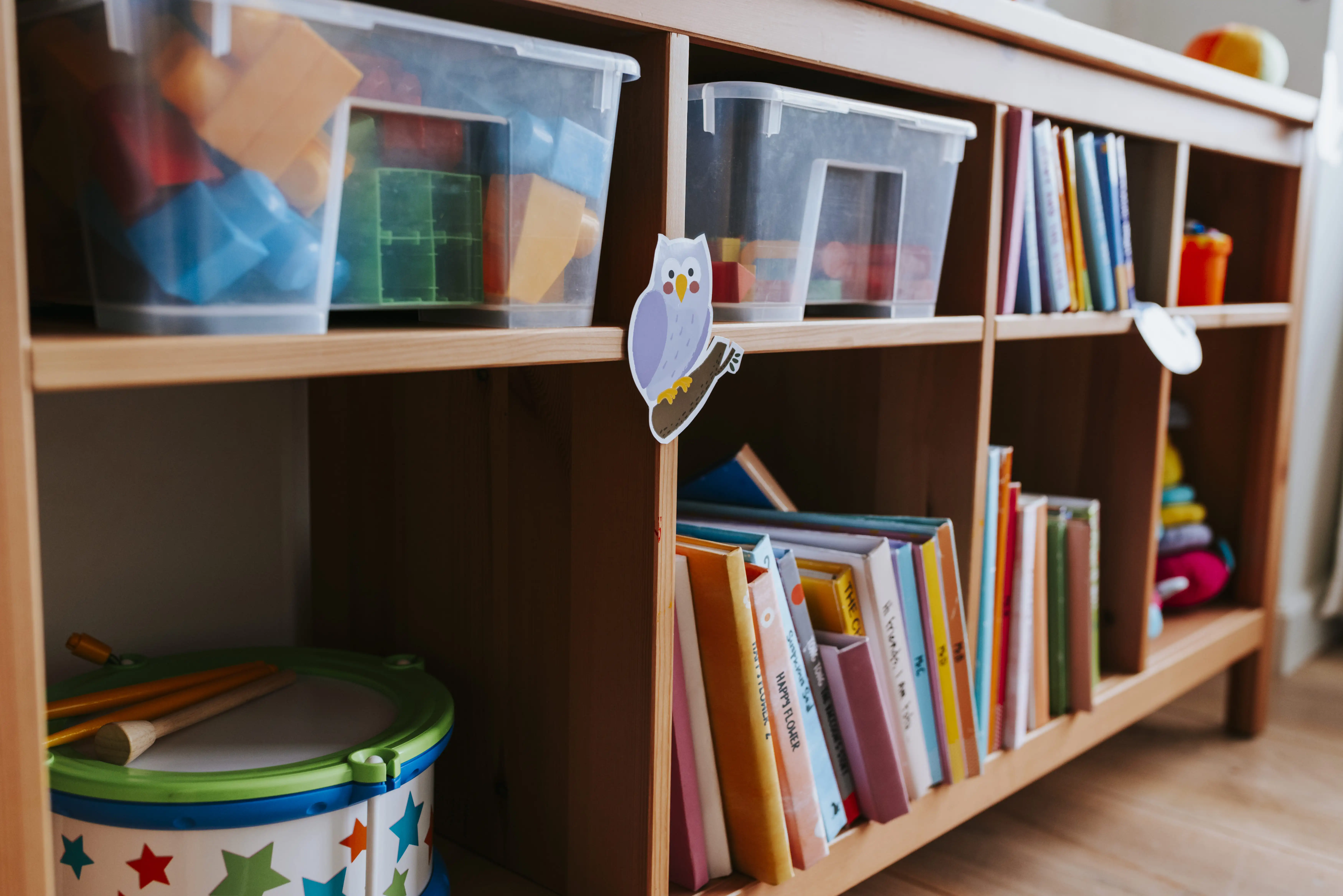 Neatly arranged building blocks are placed in the compartments of the cabinet.