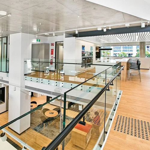 Indoor frameless stainless steel standoff glass railing with black hardware