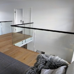 Indoor frameless stainless steel standoff glass railing with black hardware