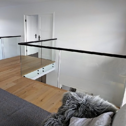Indoor frameless stainless steel standoff glass railing with black hardware