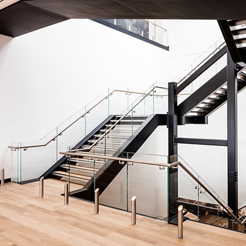 L shape wood stairs with glass railing for modern office staircase