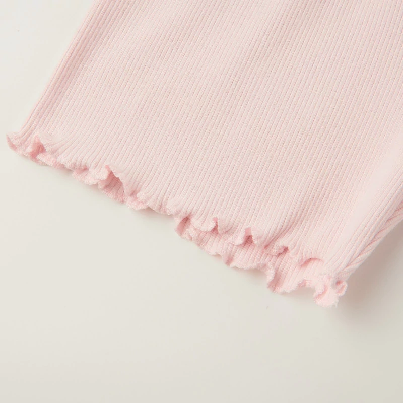 Close-up of rib knit texture and elastic waistband on baby shorts