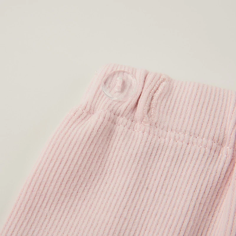 Close-up of rib knit texture and elastic waistband on baby shorts