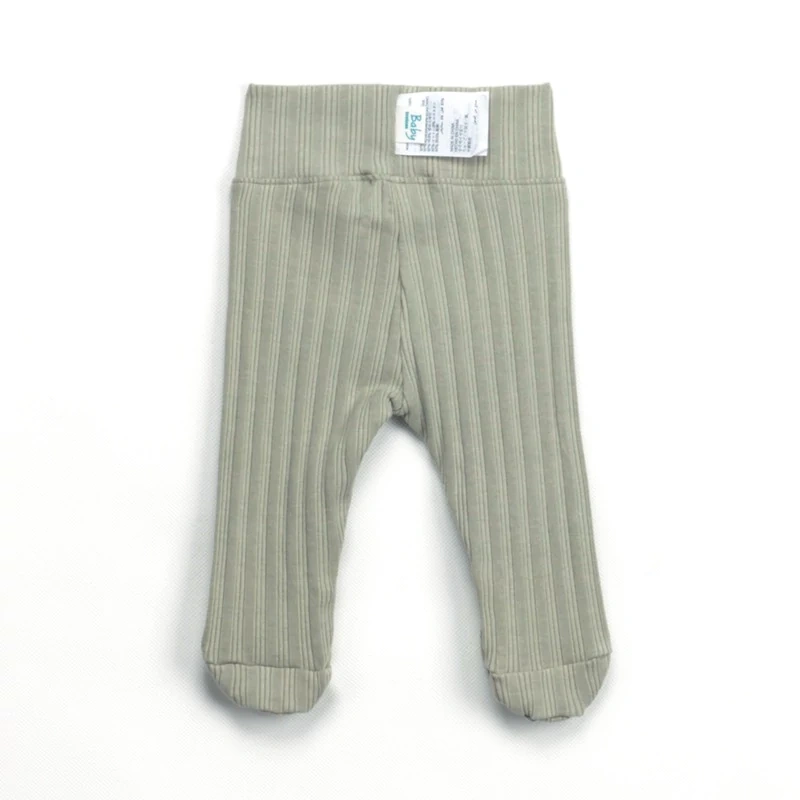Baby wearing ribbed plant-dyed organic-cotton footed pants with soft elastic waist and covered toes