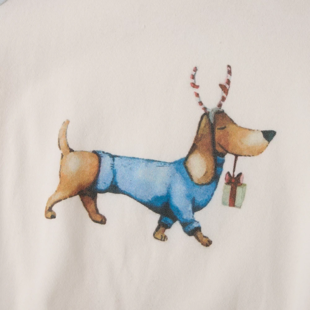 Flat-lay of festive dog baby bodysuit, soft jersey knit