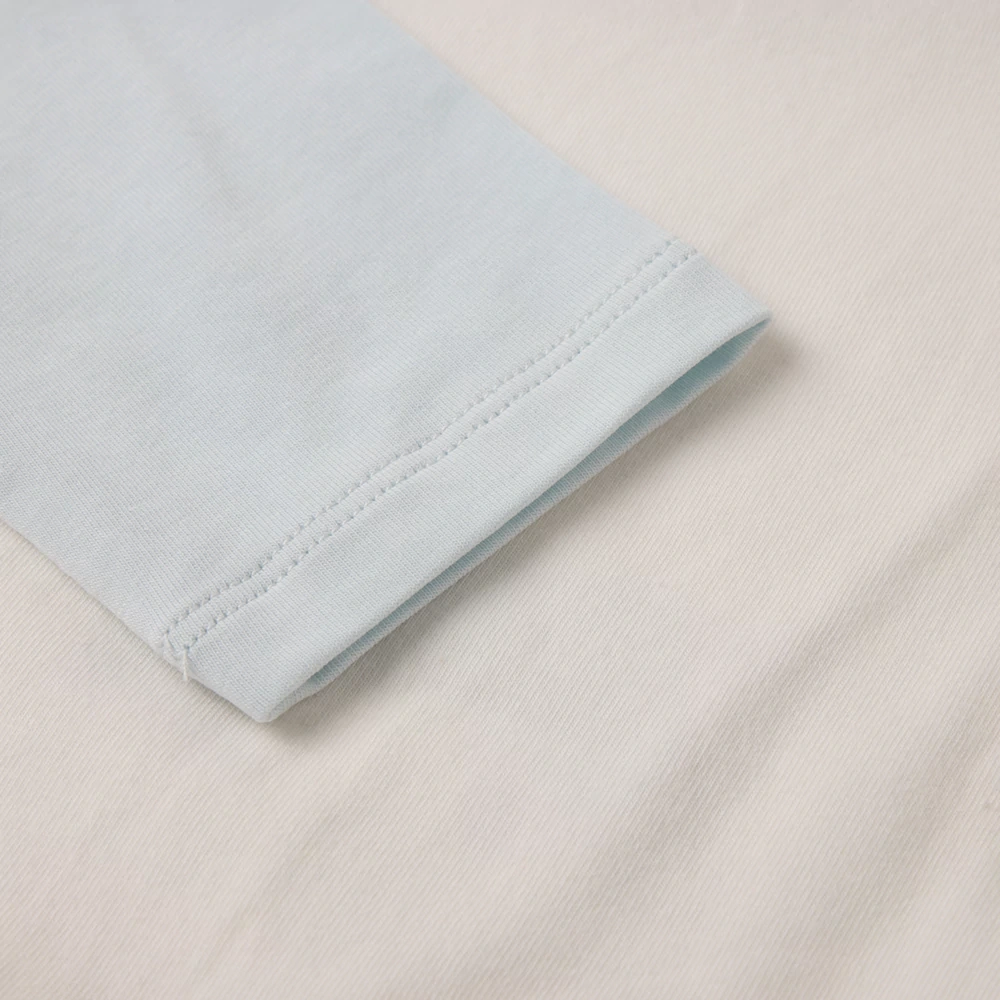 Flat-lay of festive dog baby bodysuit, soft jersey knit