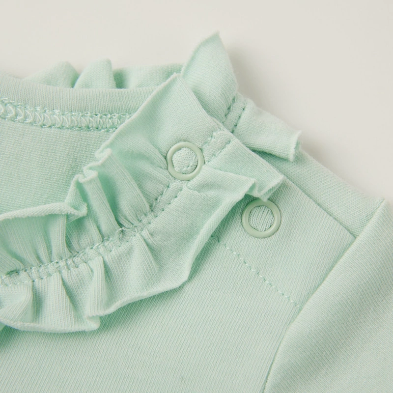 Ruffle neck close-up — naturally dyed color