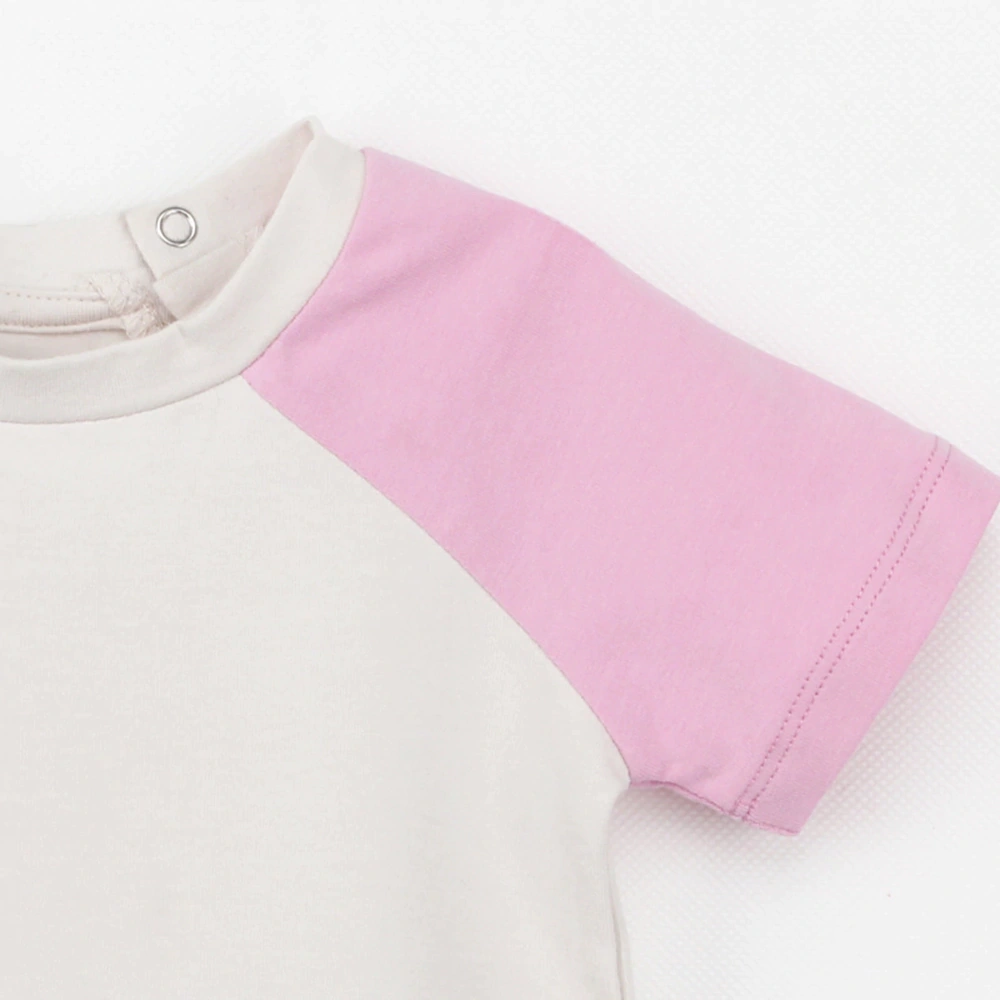 Organic plant-dyed Leo raglan short sleeve baby tee laid flat
