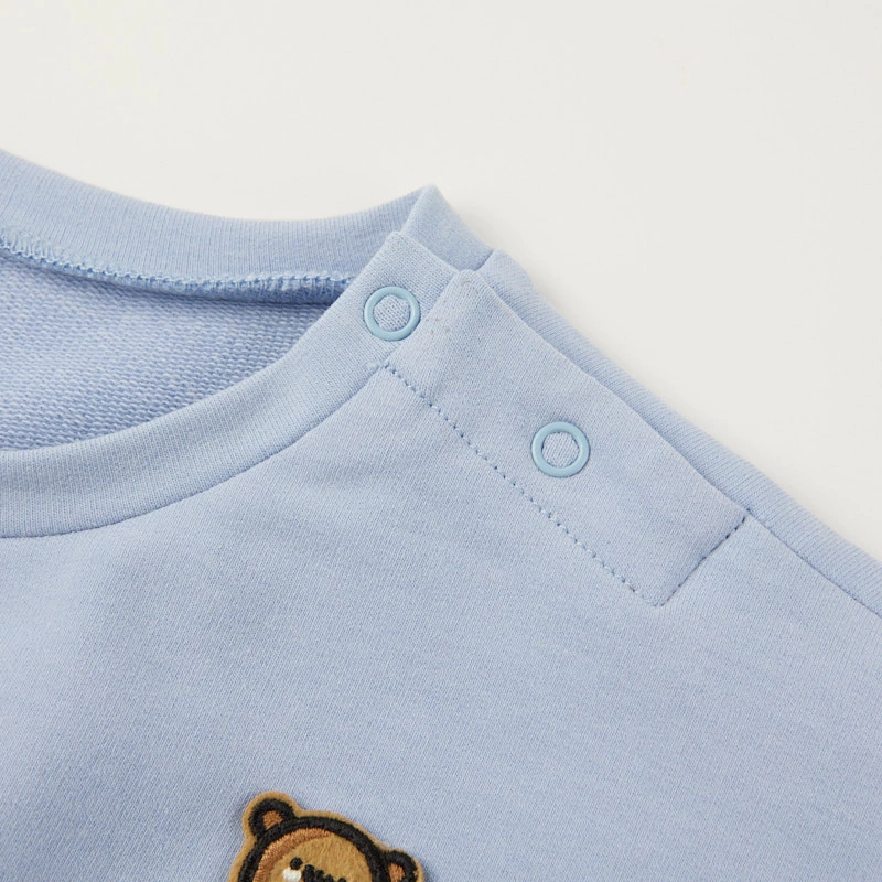Shoulder snap detail on baby bodysuit