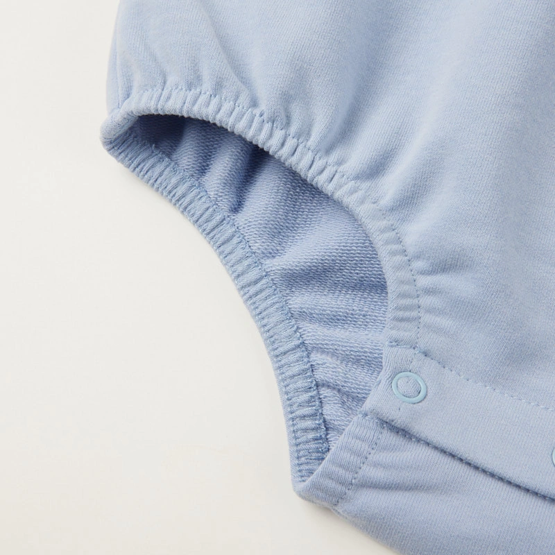 Bottom snap fasteners on baby bodysuit