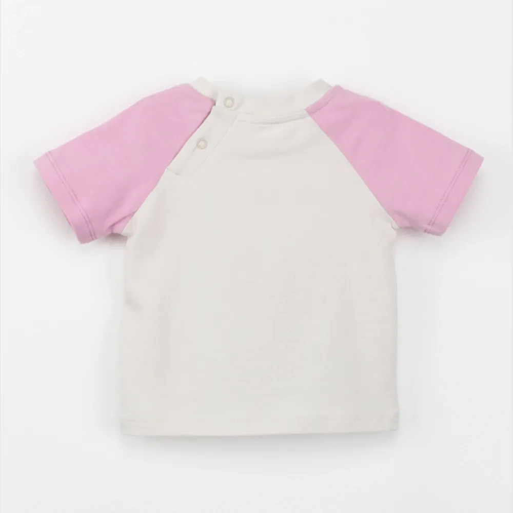 Organic plant-dyed Leo raglan short sleeve baby tee fabric and trim detail