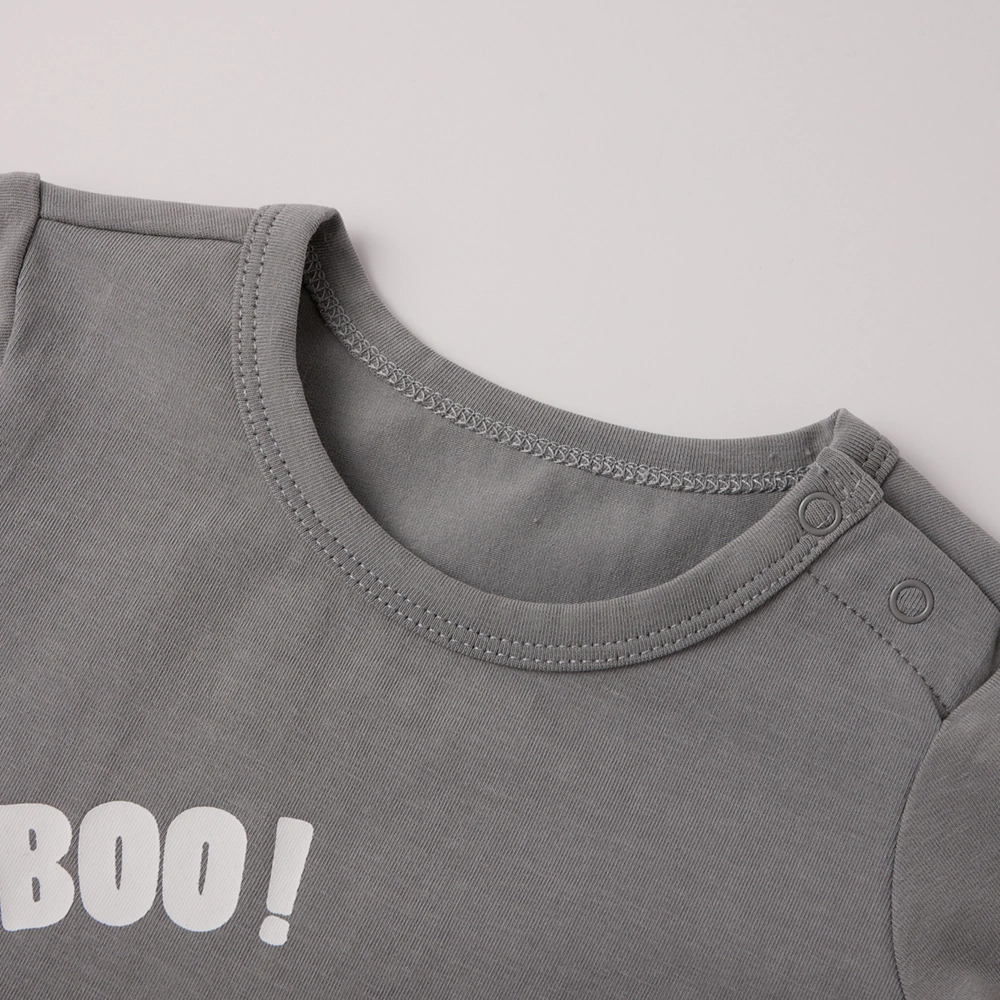 Lap-shoulder neckline detail on plant-dyed baby romper