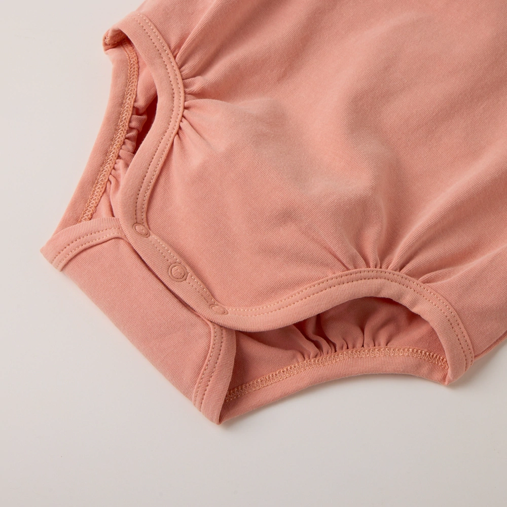 Organic pumpkin baby bodysuit and hat set made with plant-dyed GOTS organic cotton