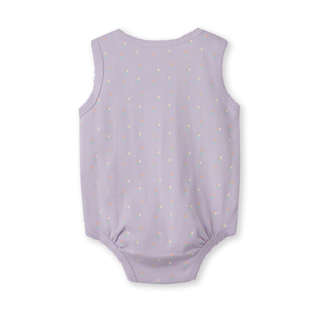 Baby girl wearing plant-dyed organic-cotton sleeveless bodysuit with snap crotch and soft bindings