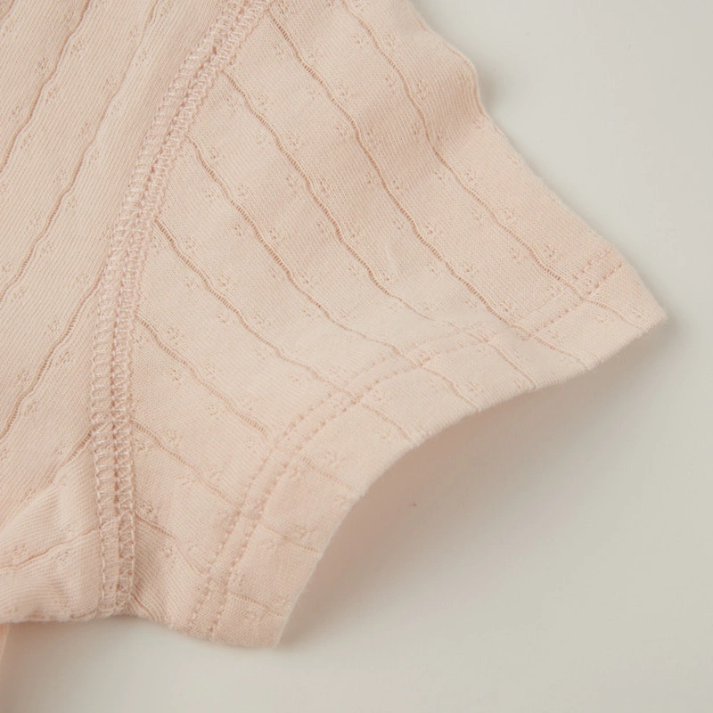 Button-up cotton jacquard baby romper in plant-dyed organic cotton