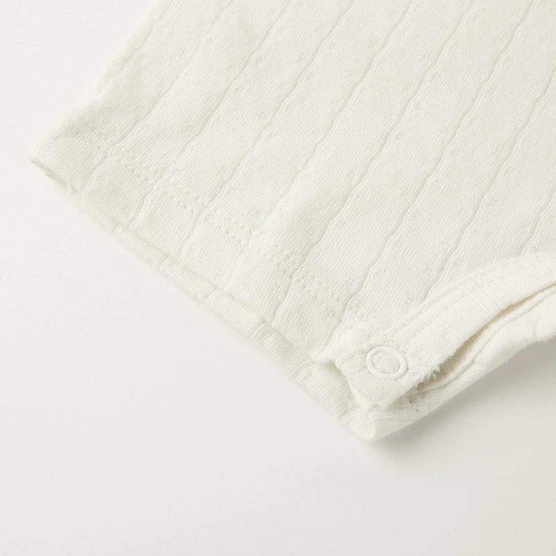 Baby wearing organic cotton plant-dyed unisex romper

