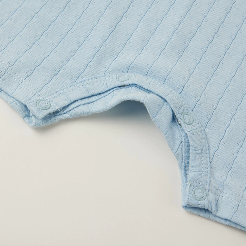 Baby wearing organic cotton plant-dyed unisex romper

