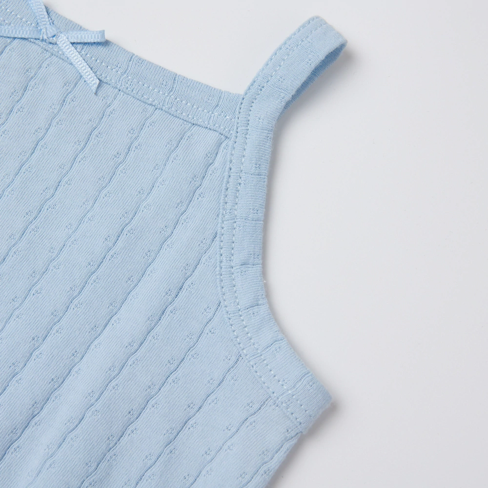 Baby girl wearing Senseng organic cotton pointelle strappy bodysuit, plant-dyed, breathable and eco-friendly