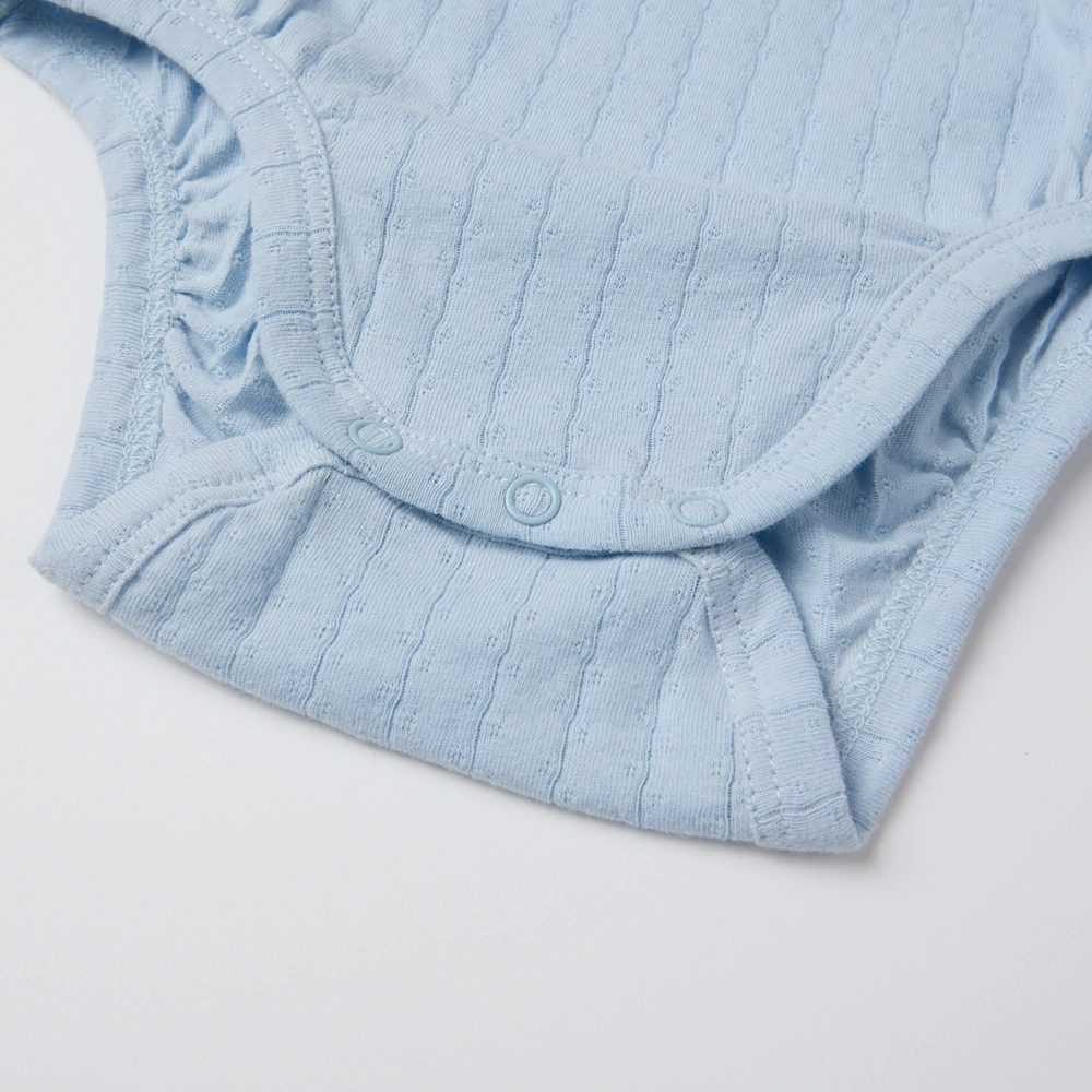 Baby girl wearing Senseng organic cotton pointelle strappy bodysuit, plant-dyed, breathable and eco-friendly