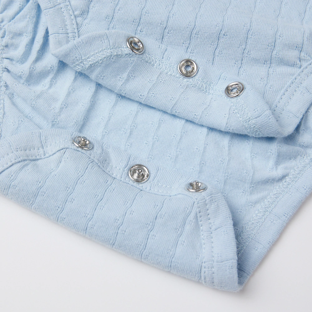 Baby girl wearing Senseng organic cotton pointelle strappy bodysuit, plant-dyed, breathable and eco-friendly