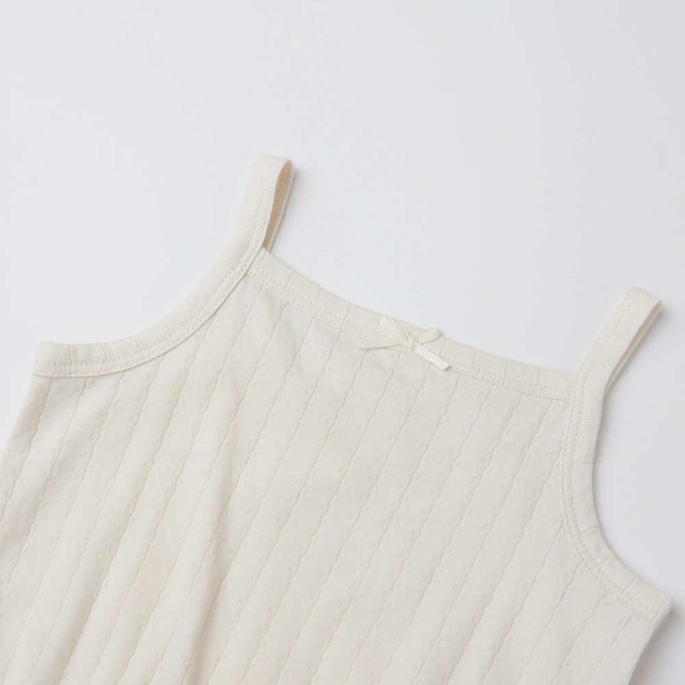 Baby girl wearing Senseng organic cotton pointelle strappy bodysuit, plant-dyed, breathable and eco-friendly