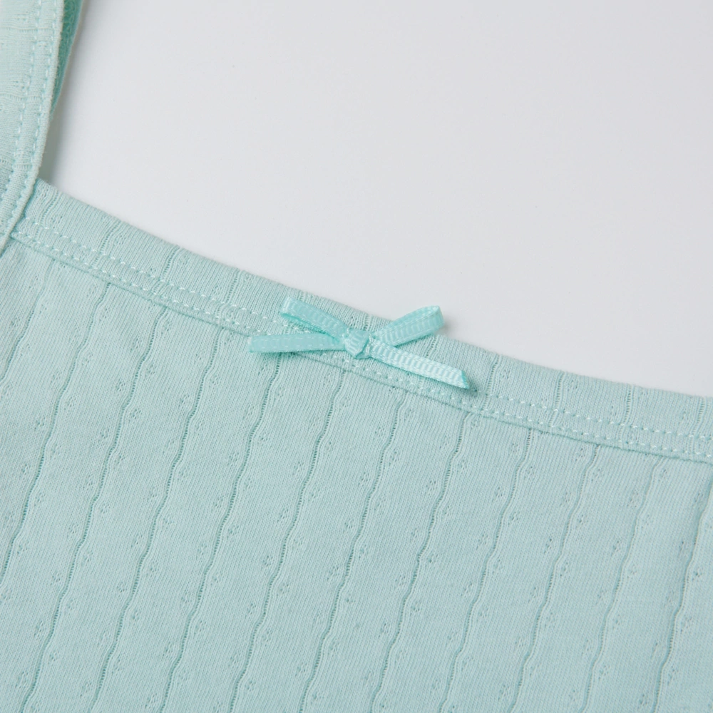 Baby girl wearing Senseng organic cotton pointelle strappy bodysuit, plant-dyed, breathable and eco-friendly