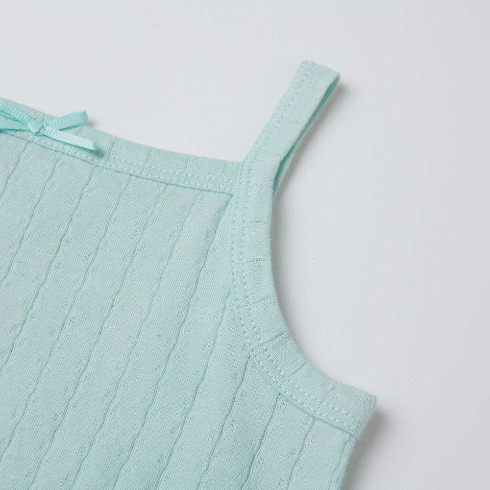 Baby girl wearing Senseng organic cotton pointelle strappy bodysuit, plant-dyed, breathable and eco-friendly