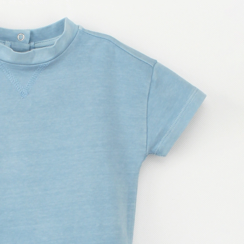 Close up of of plant-dyed organic-cotton drop-shoulder baby bodysuit with snap closure (K1230822)