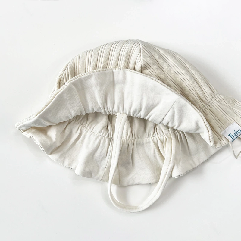 Plant-dyed organic-cotton ribbed bucket hat for babies with soft stretch lining and flexible brim. 