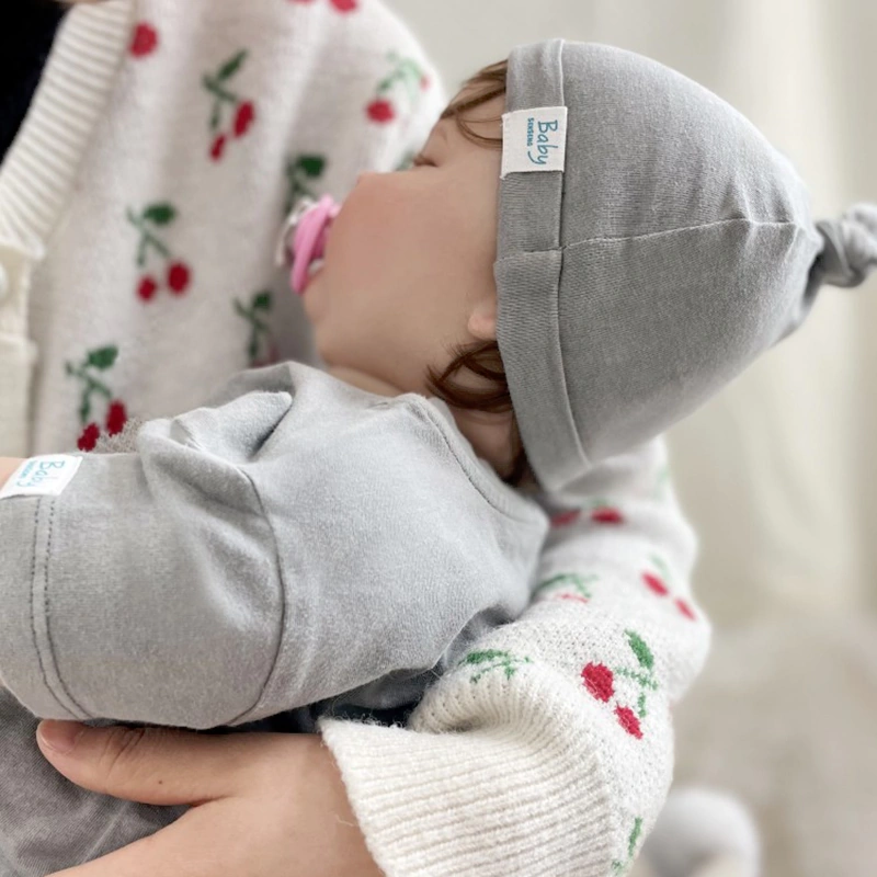 Organic-cotton baby boutique beanie in plant-dyed color with folded ear-cozy cuff 