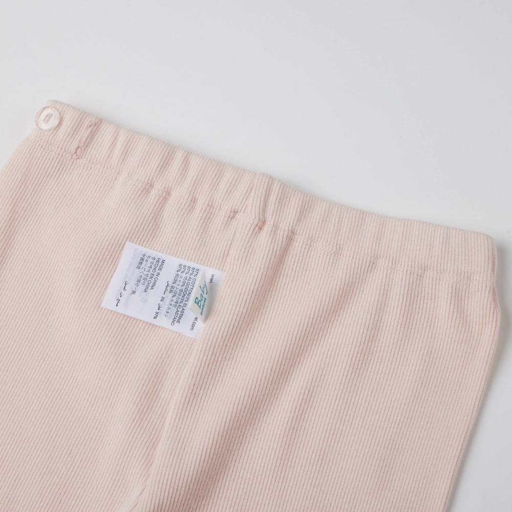 close up of back on girl long sleeve ribbed button-up top and pants set made from organic cotton with natural plant dyes