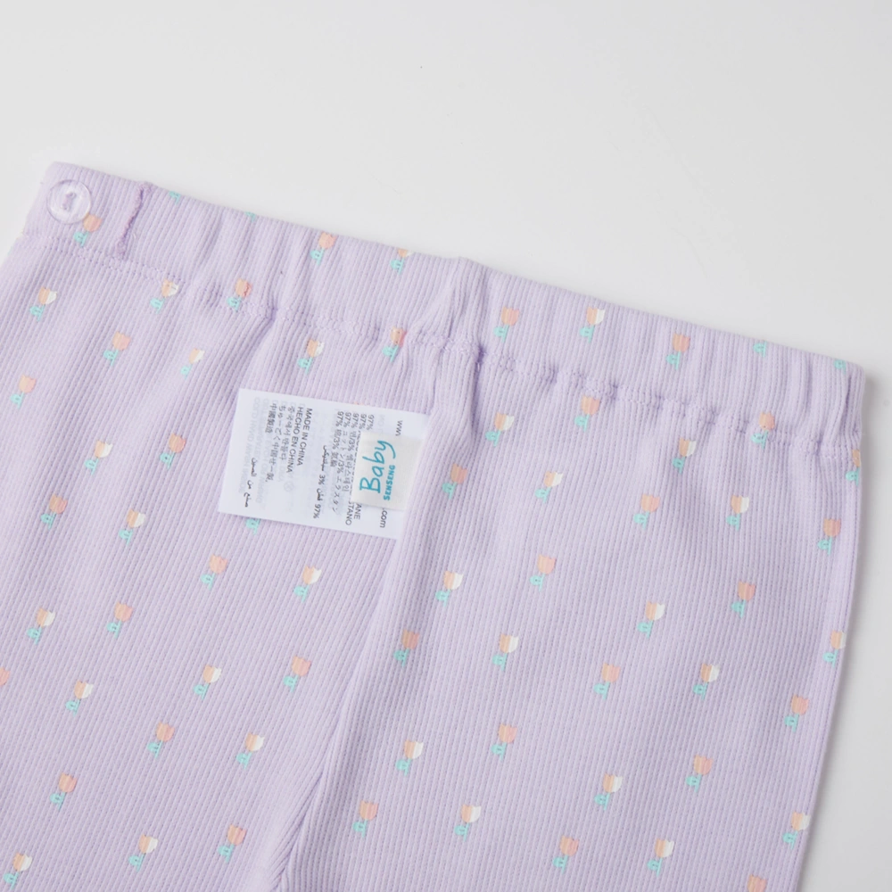 close up of back on girl long sleeve ribbed button-up top and pants set made from organic cotton with natural plant dyes