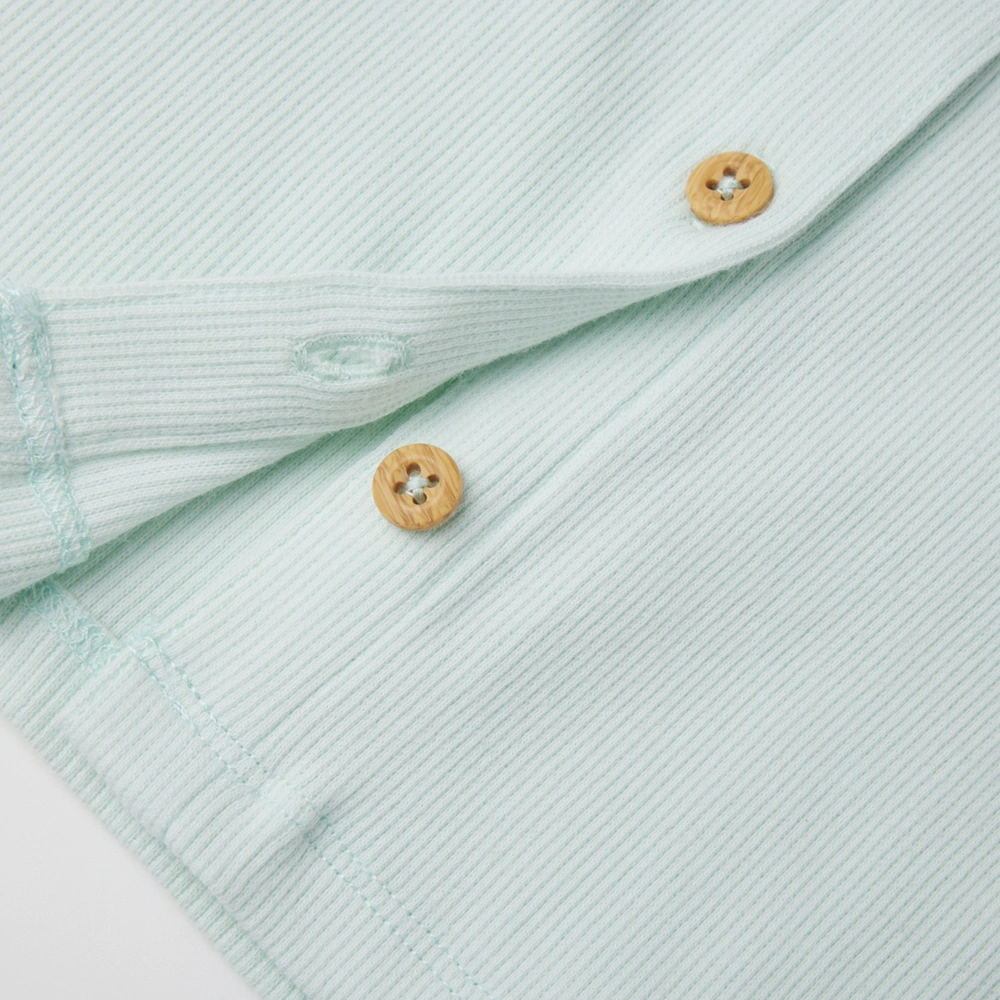 Baby girl long sleeve ribbed button-up top and pants set made from organic cotton with natural plant dyes